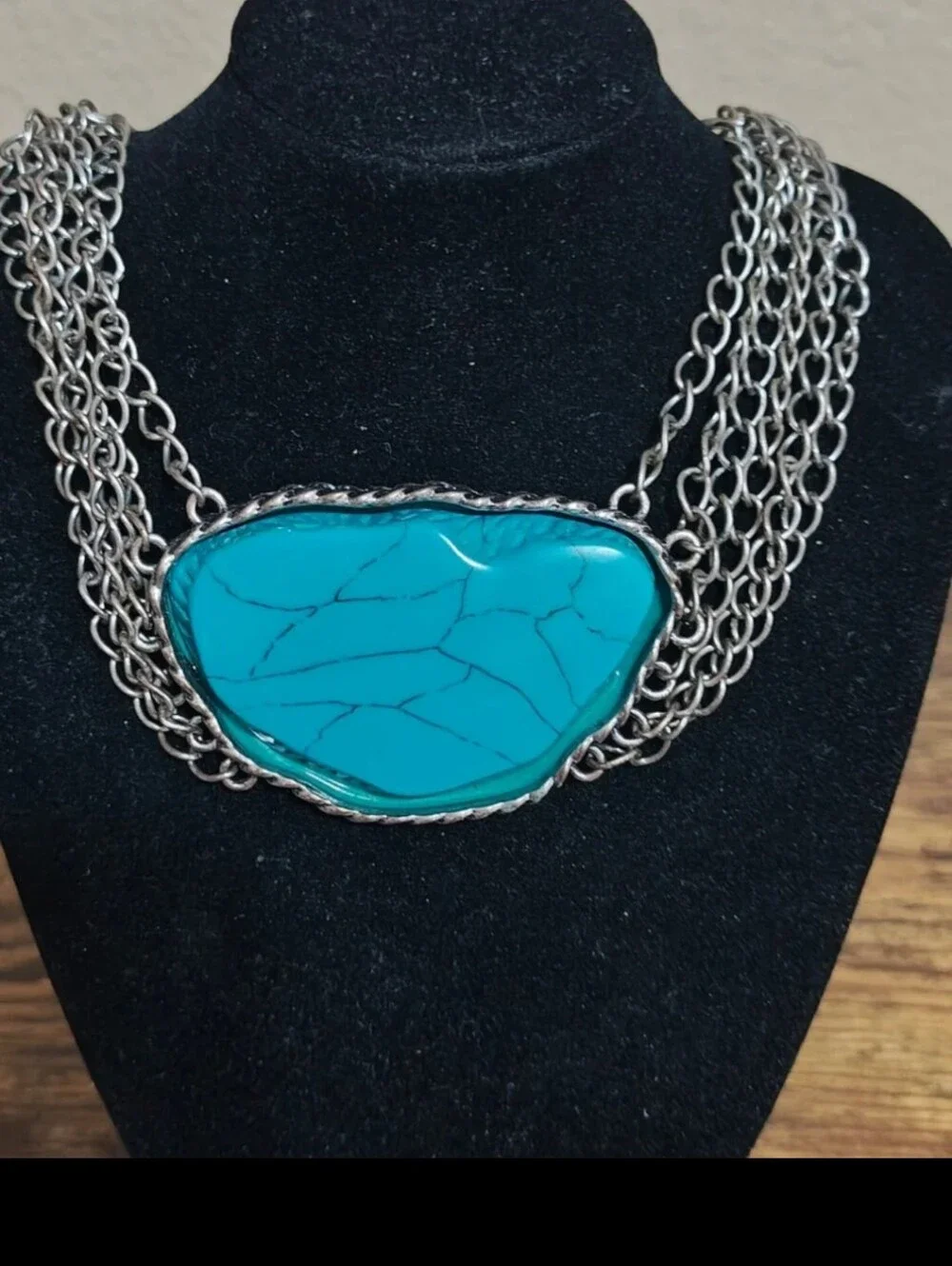 Silver Tone Multi Strand Chain Statement Necklace With a Faux Turquoise Stone